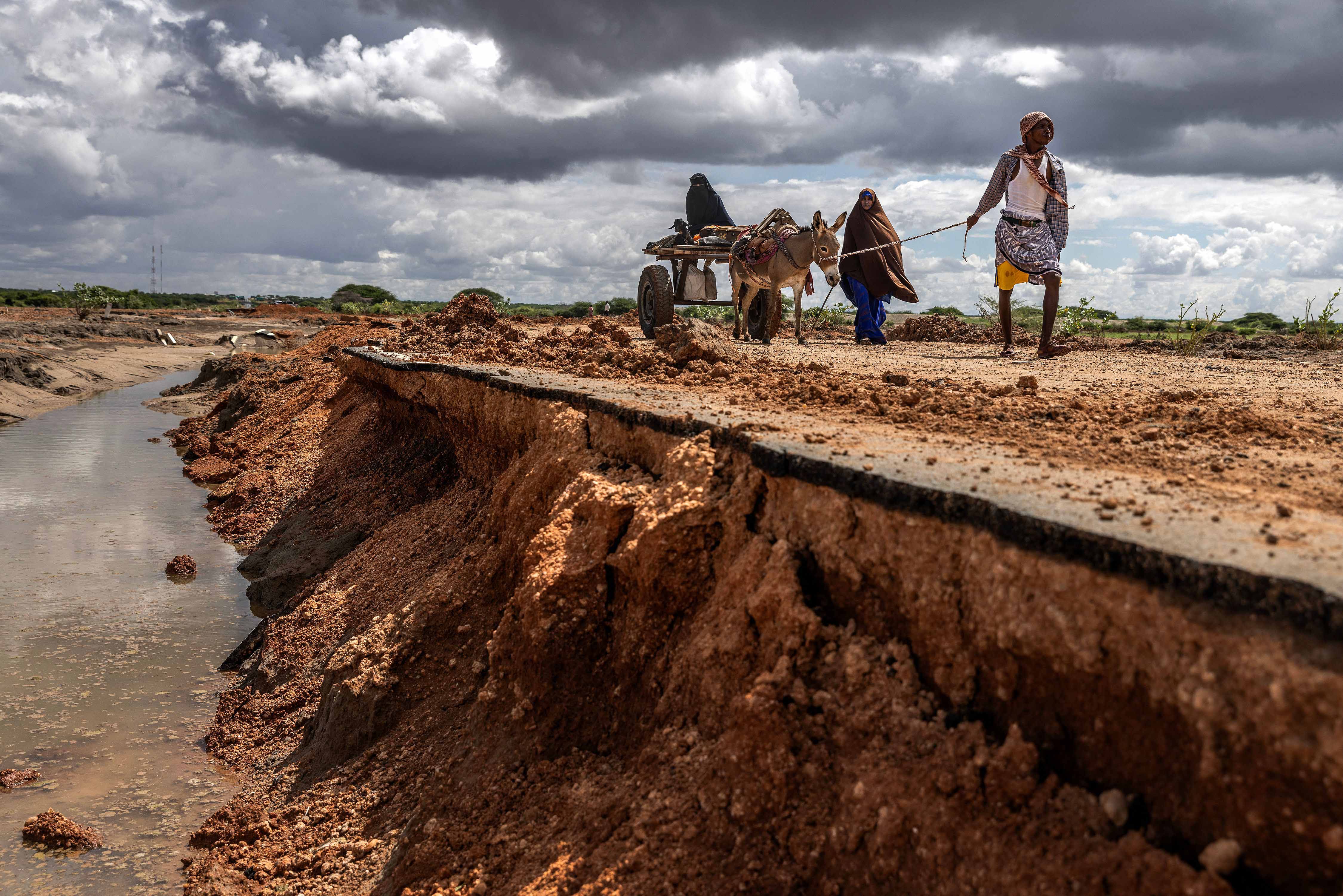 A family travels along a flood-damaged road in Garissa County, Kenya. Floods and flash floods in the east and northeast of the country contributed to its highest disaster displacement figures on record. Photo: Luis Tato/AFP/Getty Images 